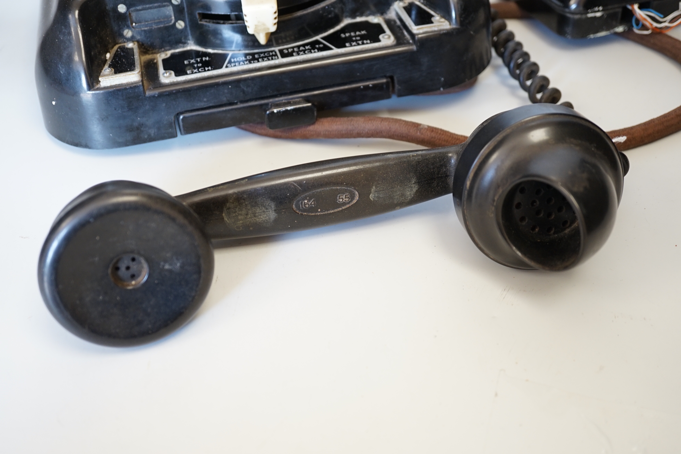 A 1930s GPO 200 series black Bakelite telephone with unusual switchboard exchange panel above drawer, with generator and connecting boxes attached